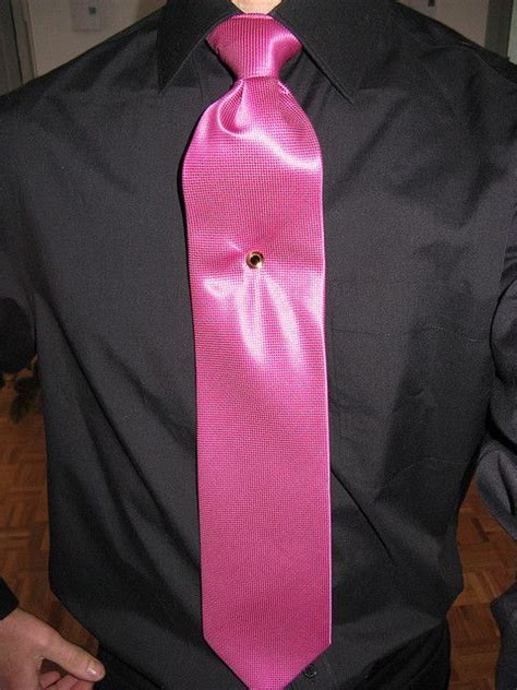 black shirt pink tie.